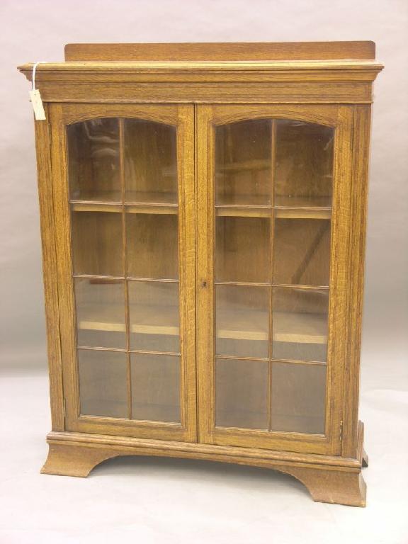 Appraisal: An unusual Edwardian inlaid solid oak bookcase the top inlaid