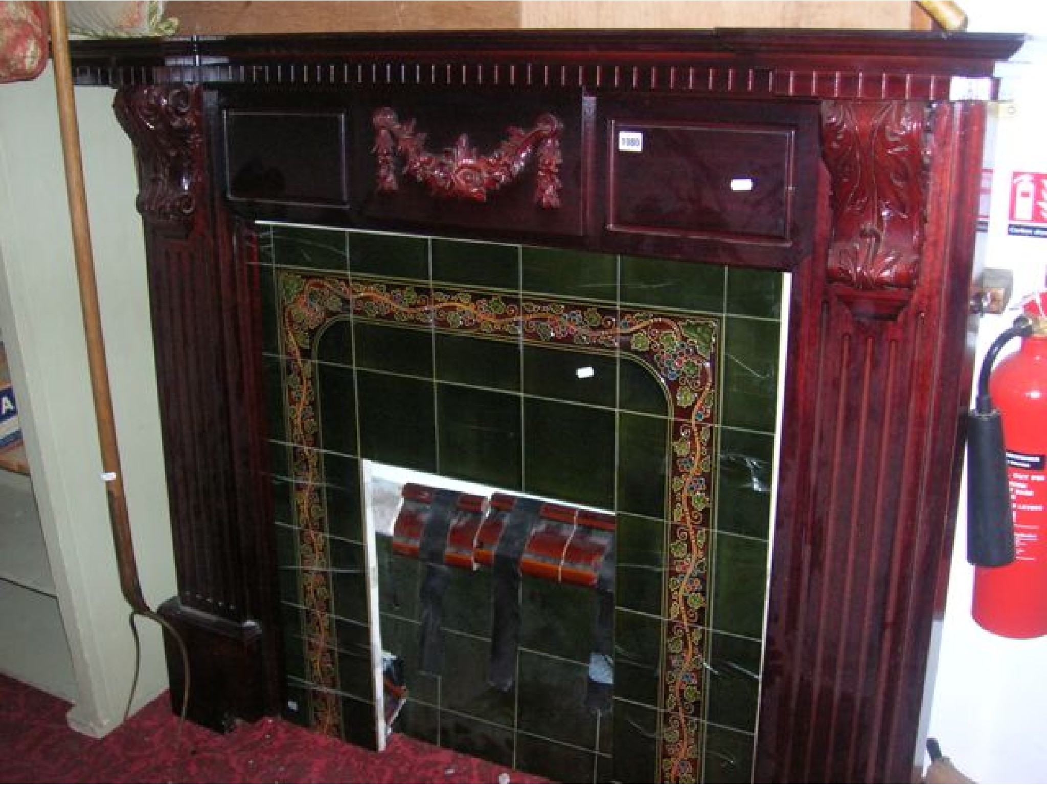 Appraisal: A reproduction stained hardwood fire surround with moulded detail scrolled