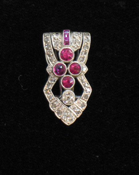 Appraisal: AN ART DECO DRESS CLIP of stylised open form pave-set