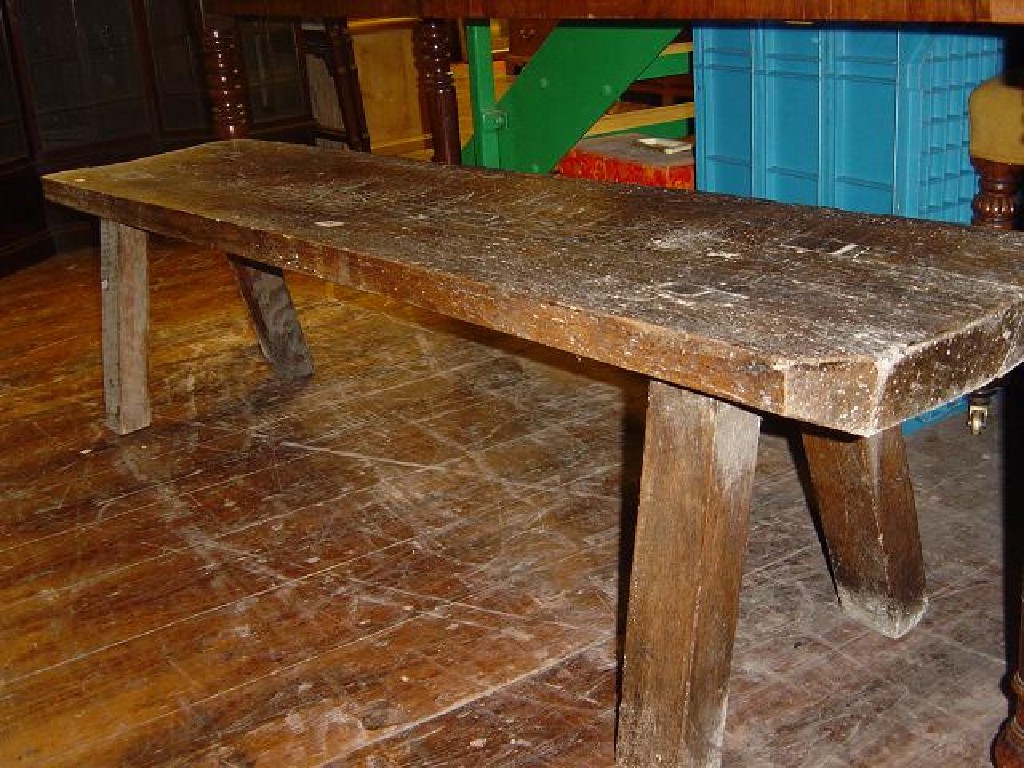 Appraisal: A rustic elm bench raised on simple square cut supports