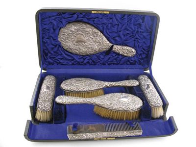 Appraisal: A six-piece Edwardian silver dressing table set comprising a mirror