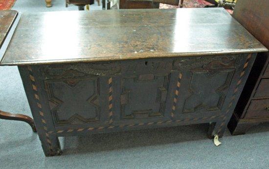 Appraisal: A th Century oak coffer plank top over dragon details