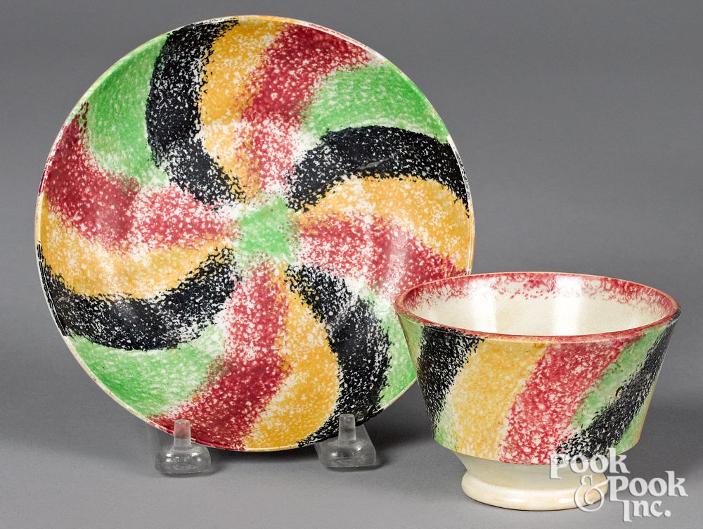 Appraisal: Rare four color rainbow spatter cup and saucer Rare four