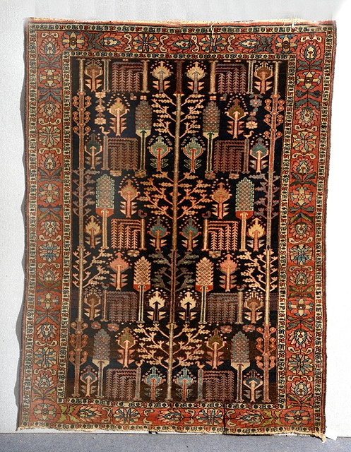 Appraisal: AN ANTIQUE PERSIAN BAKHTIARI DARK BLUE GROUND RUG with continuing