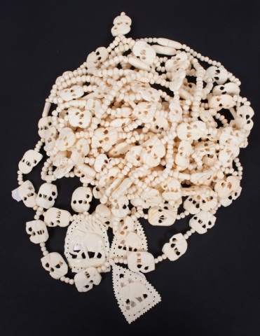 Appraisal: African carved bone necklaces with globular and elephant-form beads and