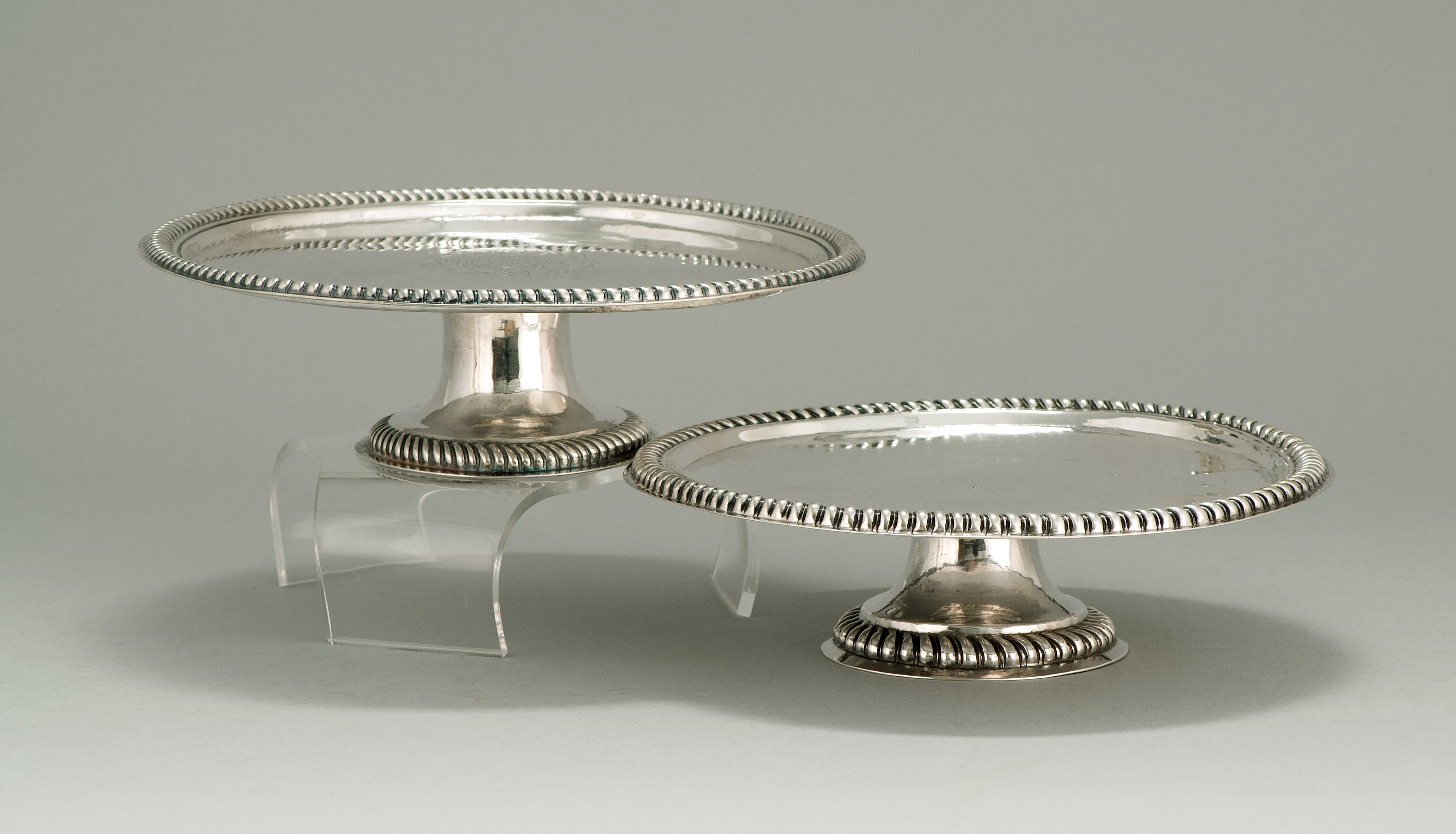 Appraisal: TWO SIMILAR SILVER CAKE STANDS English th CenturyEach with gadrooned