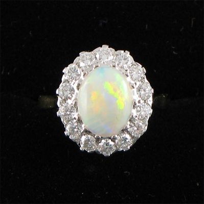 Appraisal: An opal and diamond cluster ring the oval shaped white