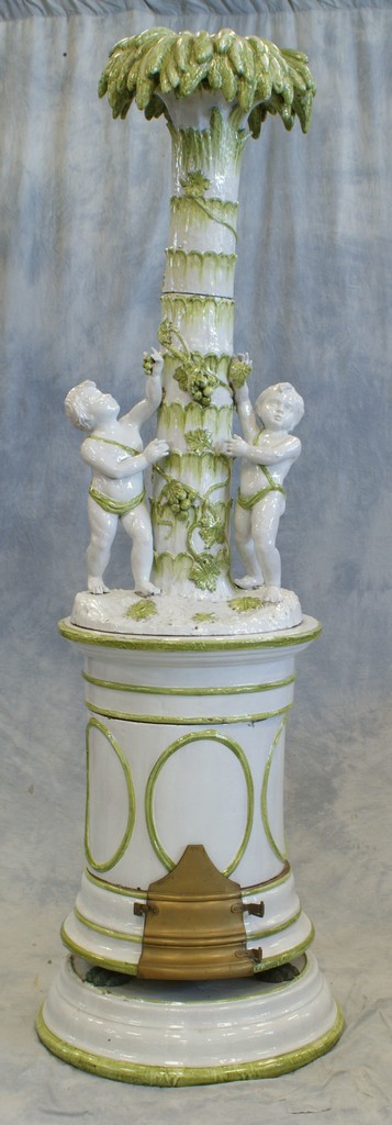 Appraisal: -Section ceramic European heater palm tree top section with cherubs