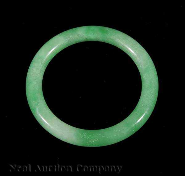 Appraisal: A Chinese Jadeite Bangle Bracelet tubular band carved of mottled