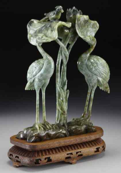 Appraisal: Chinese carved jadeite statue depicting two egretswith lotus Without stand