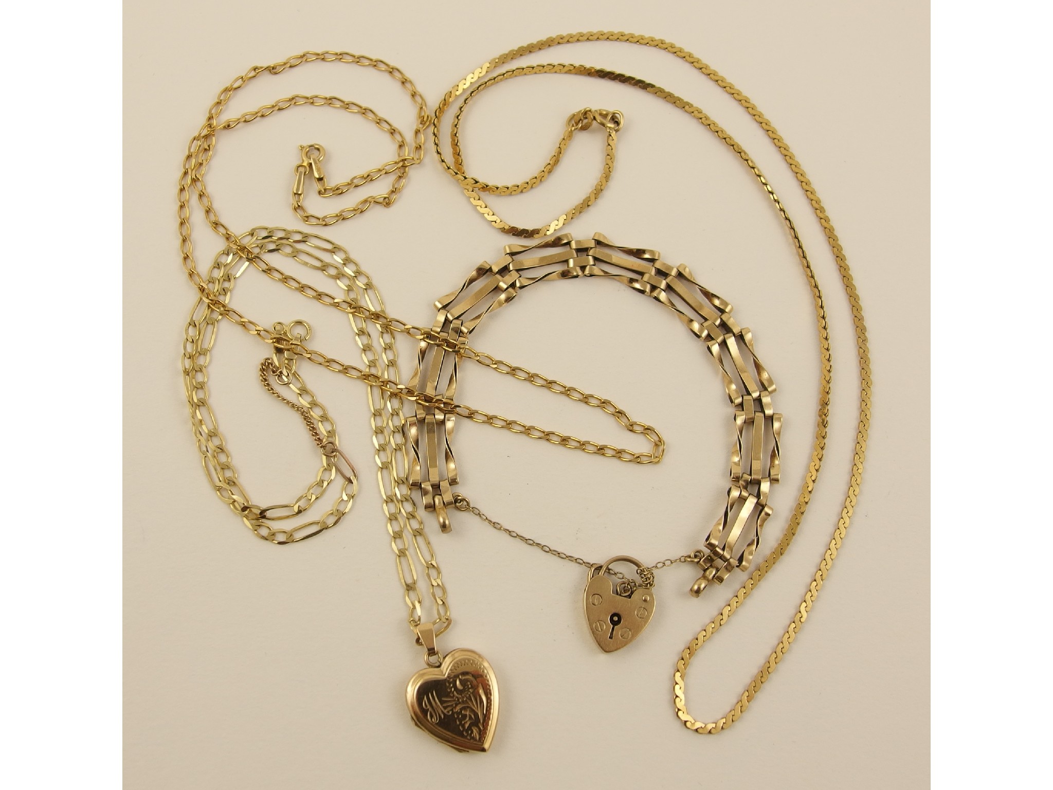 Appraisal: A ct gate bracelet three ct chains and a locket