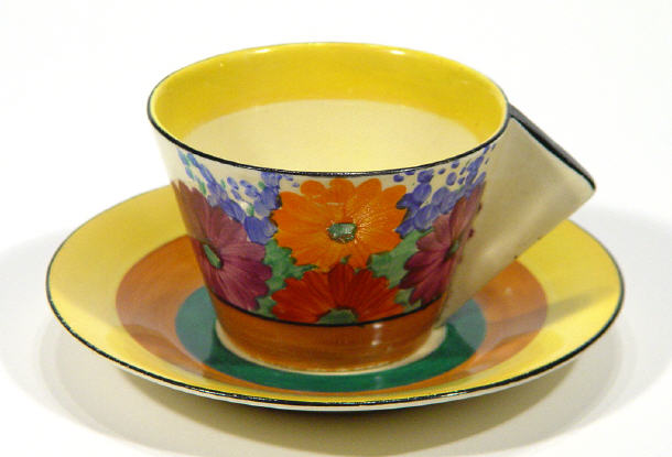 Appraisal: Clarice Cliff Bizarre angular handled teacup and saucer hand painted