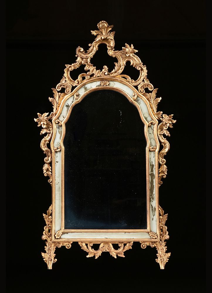 Appraisal: A GEORGE II STYLE CARVED AND PARCEL GILT WOOD MIRROR