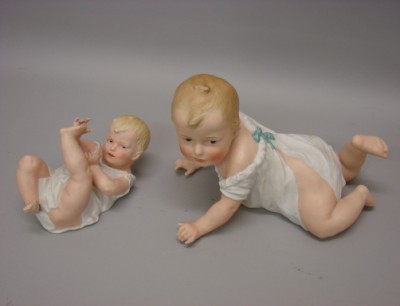 Appraisal: -Heubach type Piano babies L Unmarked reclining on back holding