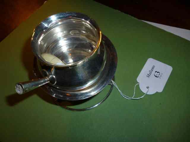 Appraisal: A SILVER BRANDY WARMER AND STAND with turned ivory handle