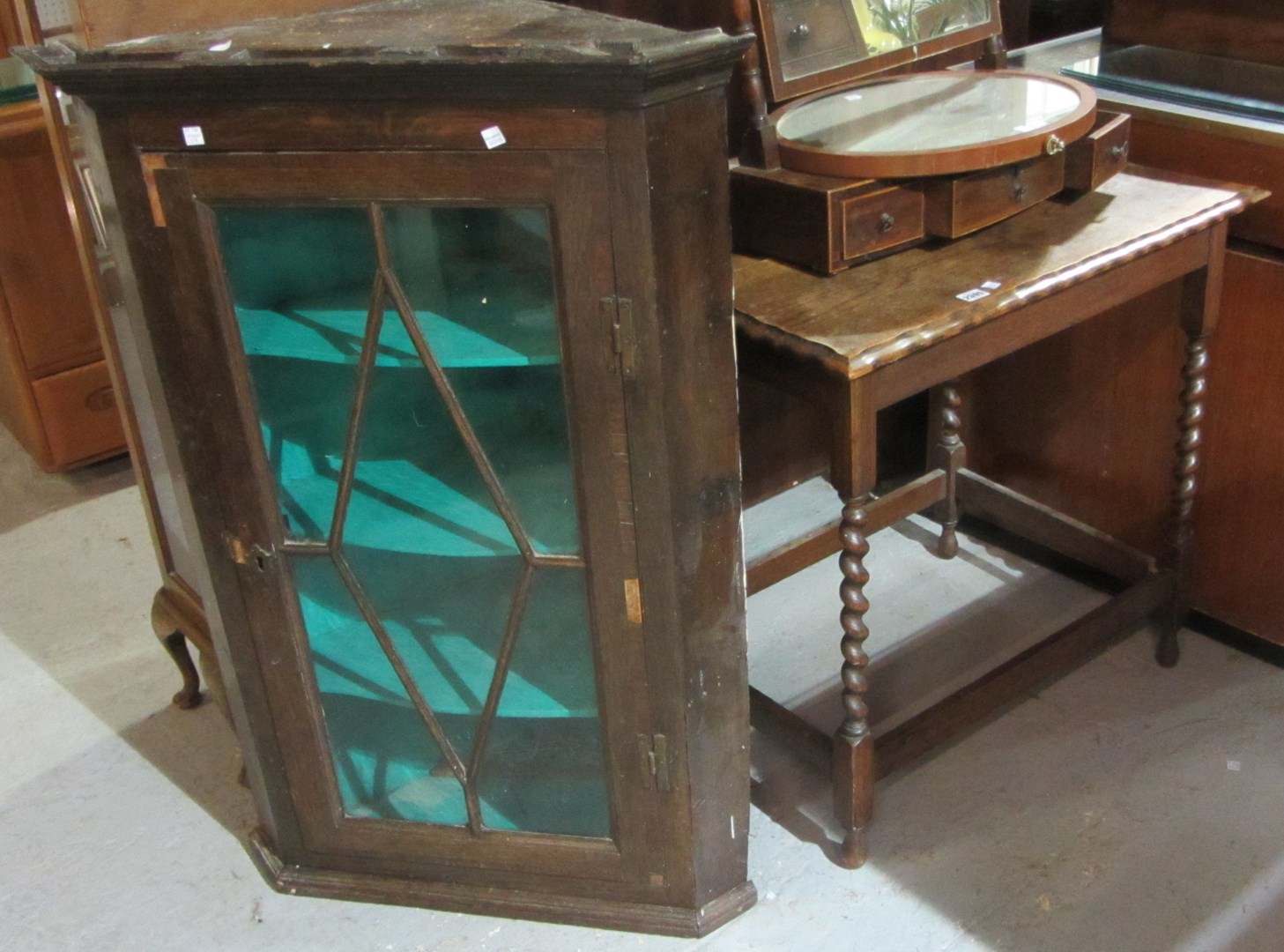 Appraisal: An oak rectangular occasional table and a mahogany corner cupboard