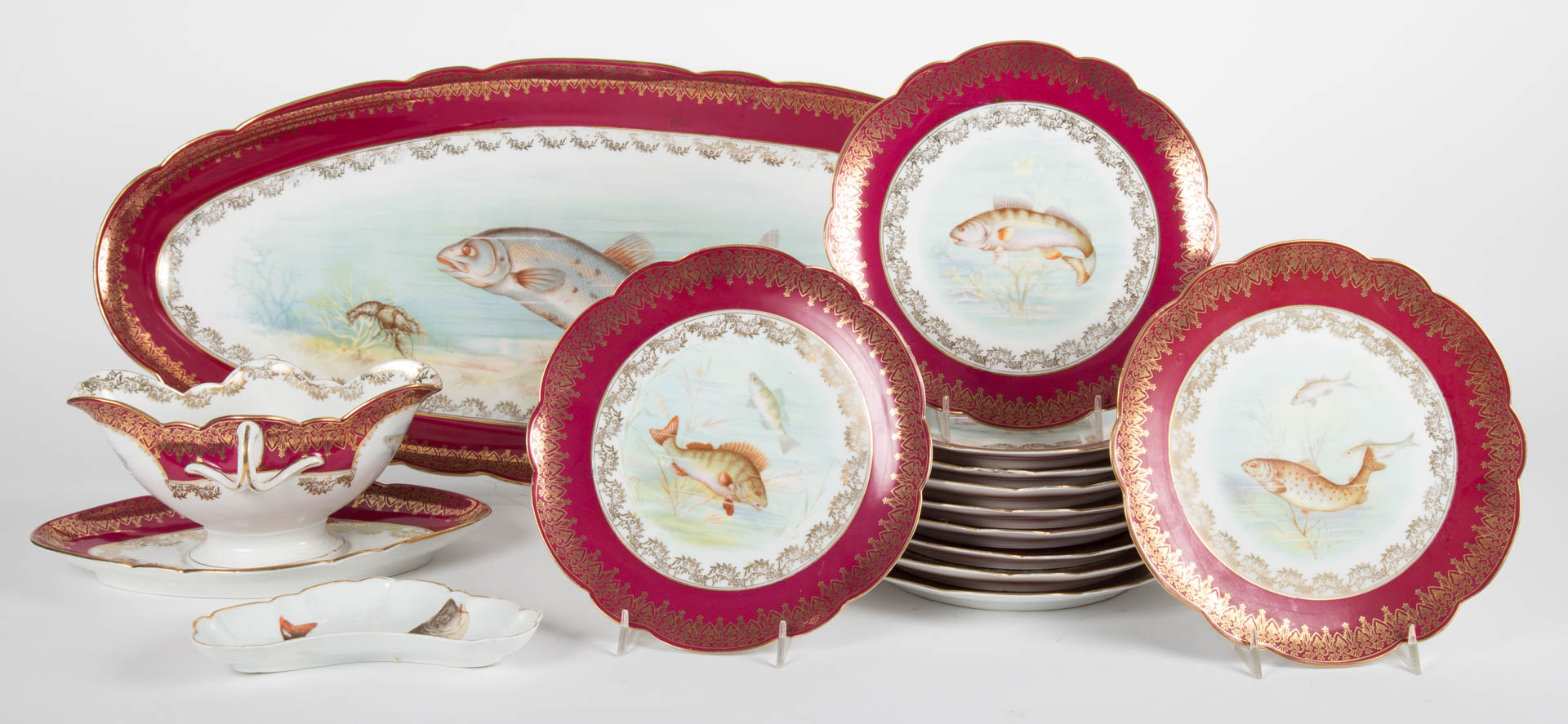 Appraisal: German paint-transfer fish set late th century each piece with