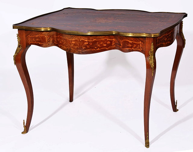 Appraisal: A FRENCH KINGWOOD AND FLORAL MARQUETRY SERPENTINE WRITING TABLE with