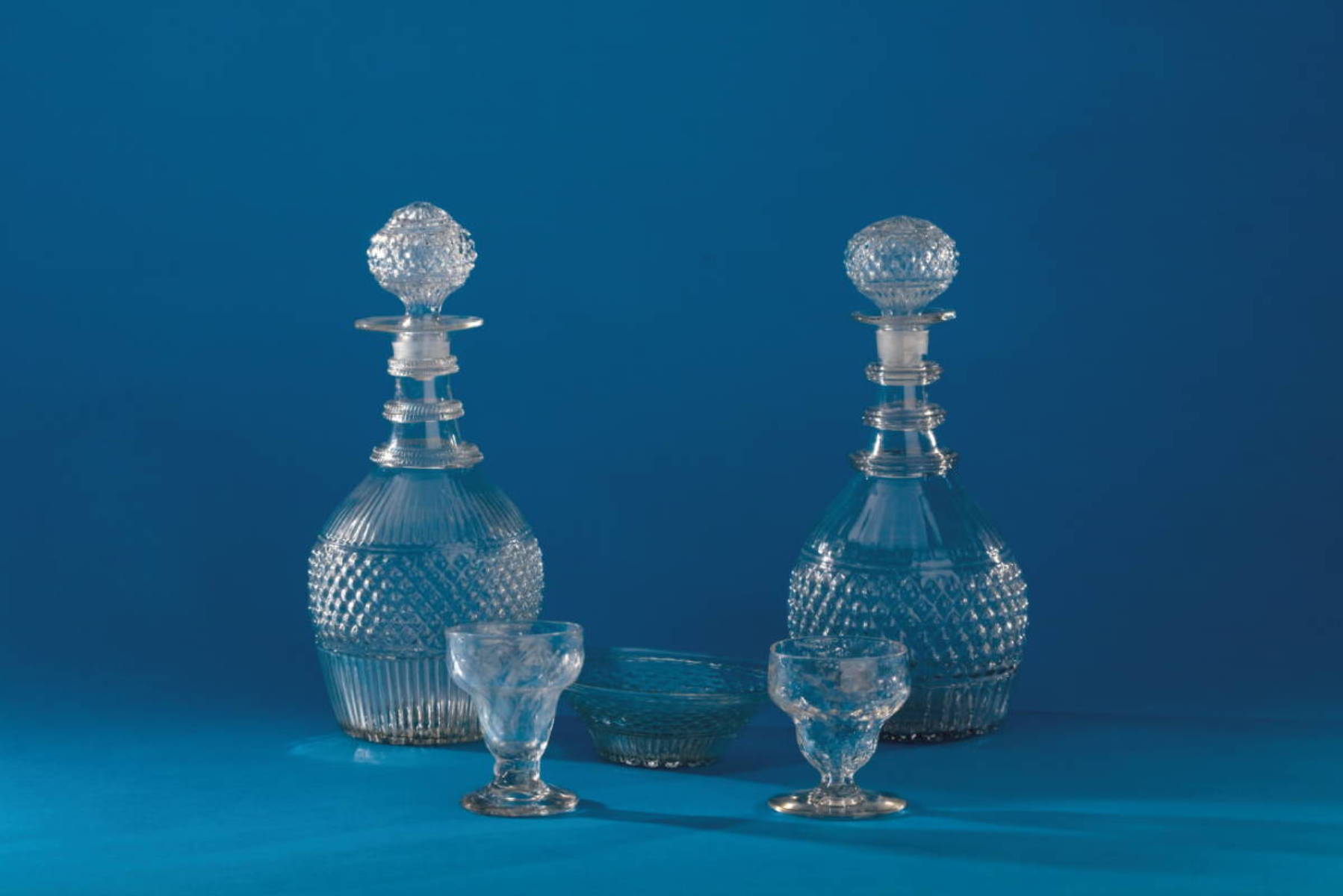 Appraisal: TWO BLOWN THREE-MOLD COLORLESS GLASS GII- PATTERN DECANTERS AND STOPPERS