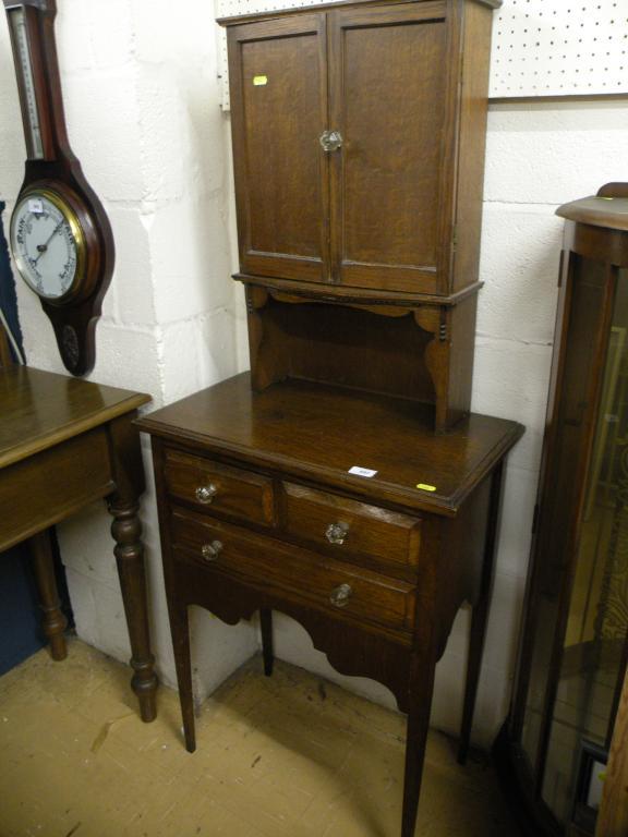 Appraisal: A small oak side cabinet the top with two panel