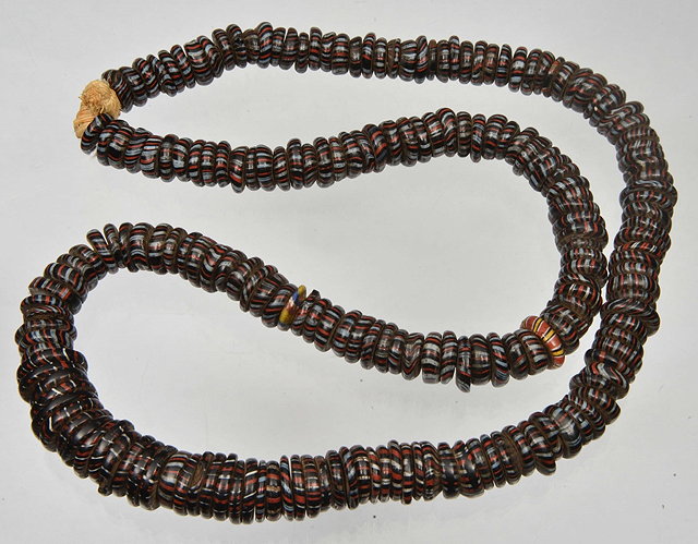 Appraisal: A VENETIAN GLASS BEAD NECKLACE with flattened traded beads long