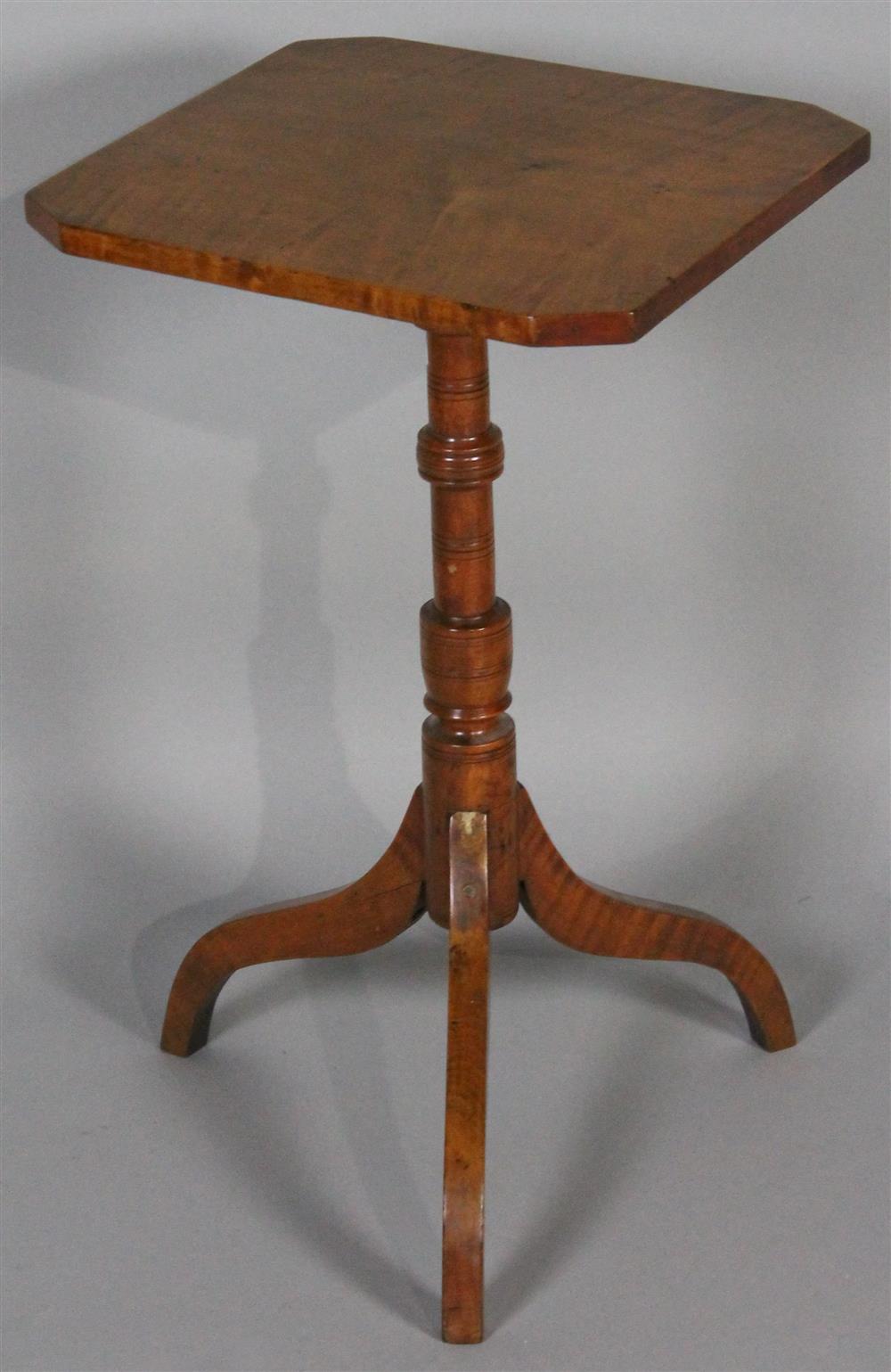 Appraisal: AMERICAN FIGURED CHERRYWOOD CANDLESTAND th C having rectangular top with