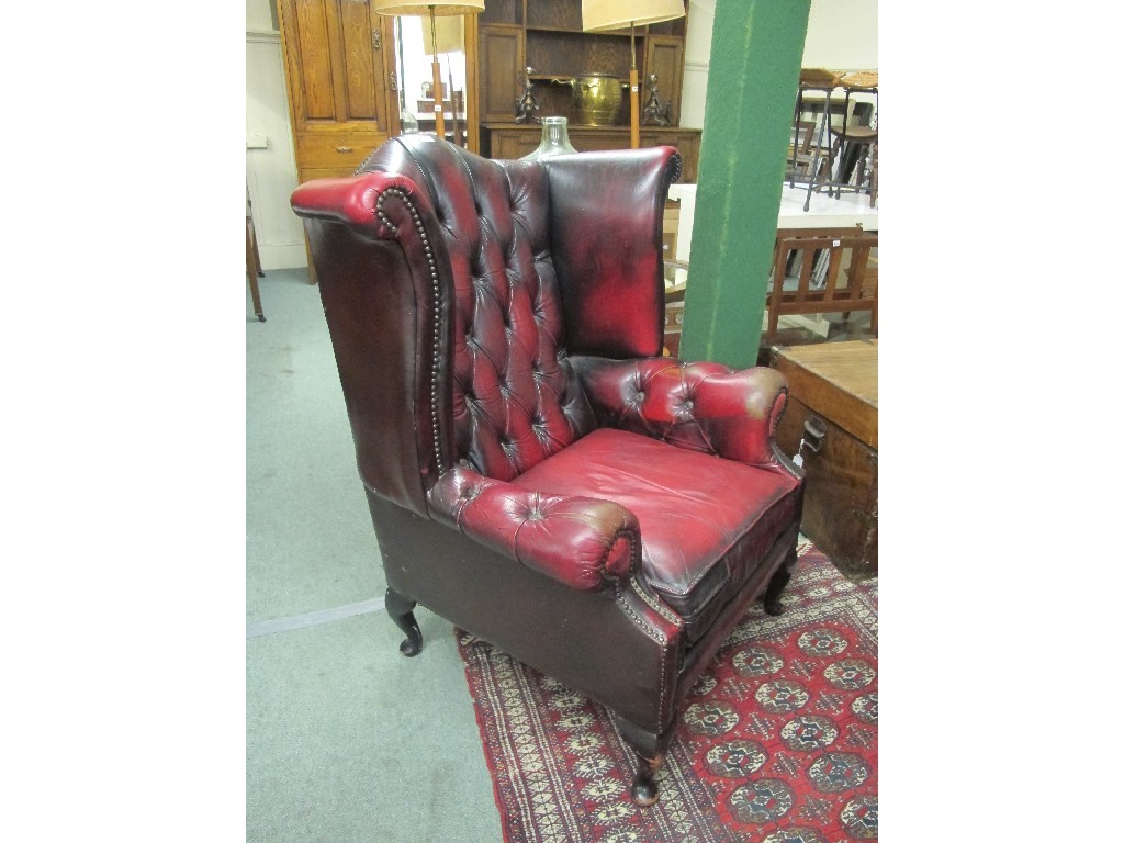 Appraisal: Chesterfield ox-blood button back wing armchair