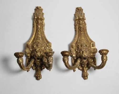 Appraisal: A pair of carved and gilded two-light wall lights the