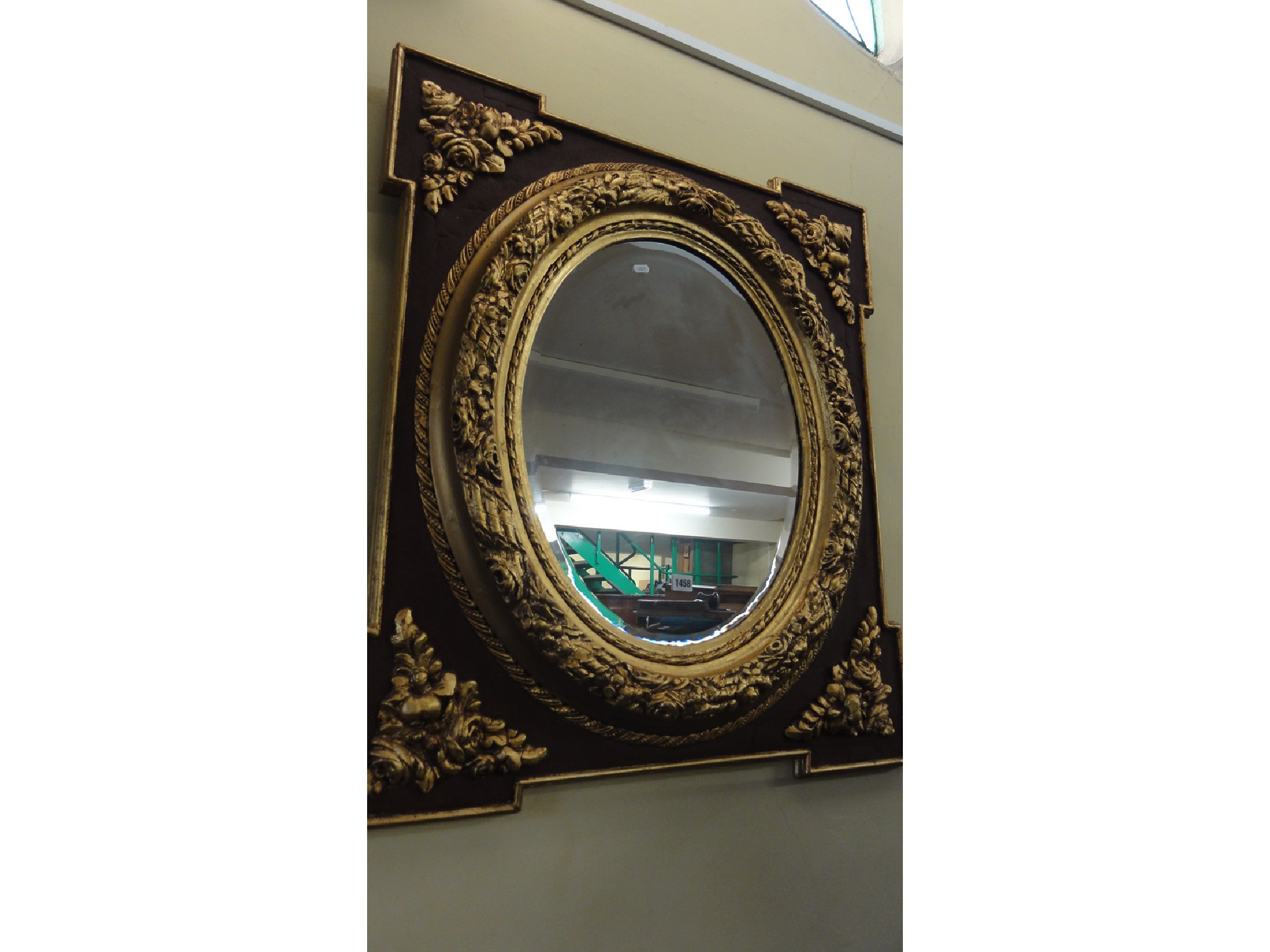 Appraisal: A wall mirror the plate of oval form with bevelled