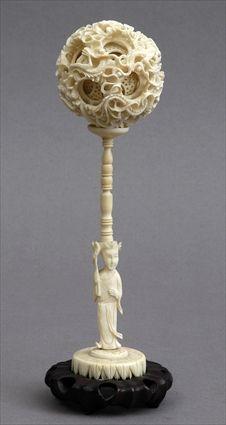 Appraisal: CHINESE CARVED IVORY PUZZLE BALL ON FIGURAL STAND Pierced and