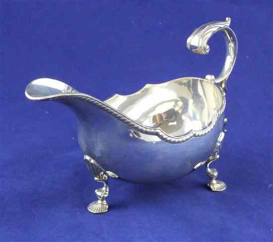 Appraisal: A modern silver sauceboat with gadrooned rim R E P