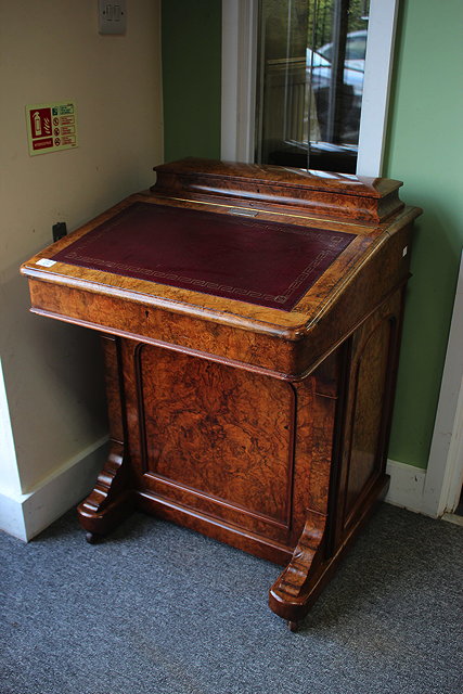 Appraisal: A BURR WALNUT DAVENPORT with a red leather inset sloping