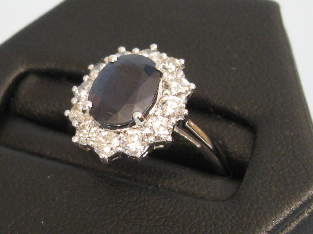 Appraisal: A Sapphire and Diamond Cluster Ring claw-set with an oval