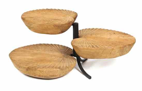 Appraisal: A Three Tiered Occasional Table having rotating carved leaf form