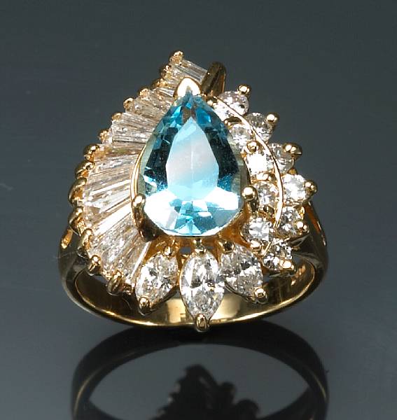 Appraisal: A blue topaz diamond and k gold ring estimated total