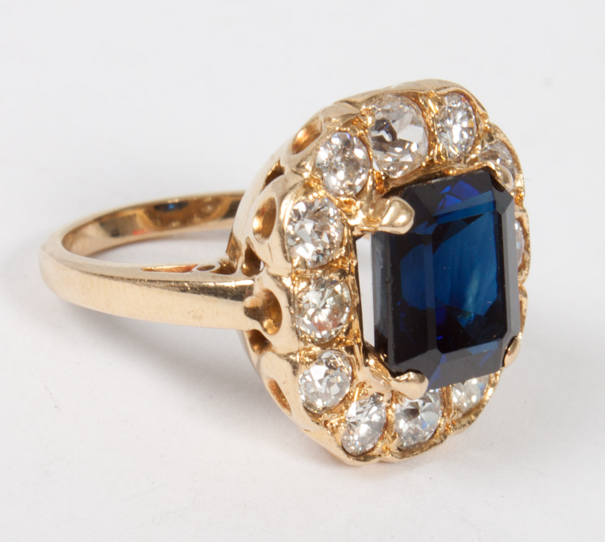 Appraisal: Lady's gold sapphire and diamond ring emerald-cut sapphire surrounded by