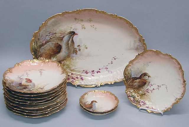 Appraisal: Hand-painted bird and flower decoration on molded ground gilt trim