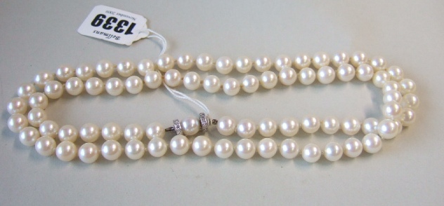 Appraisal: A single row necklace of uniform cultured pearls the diamond