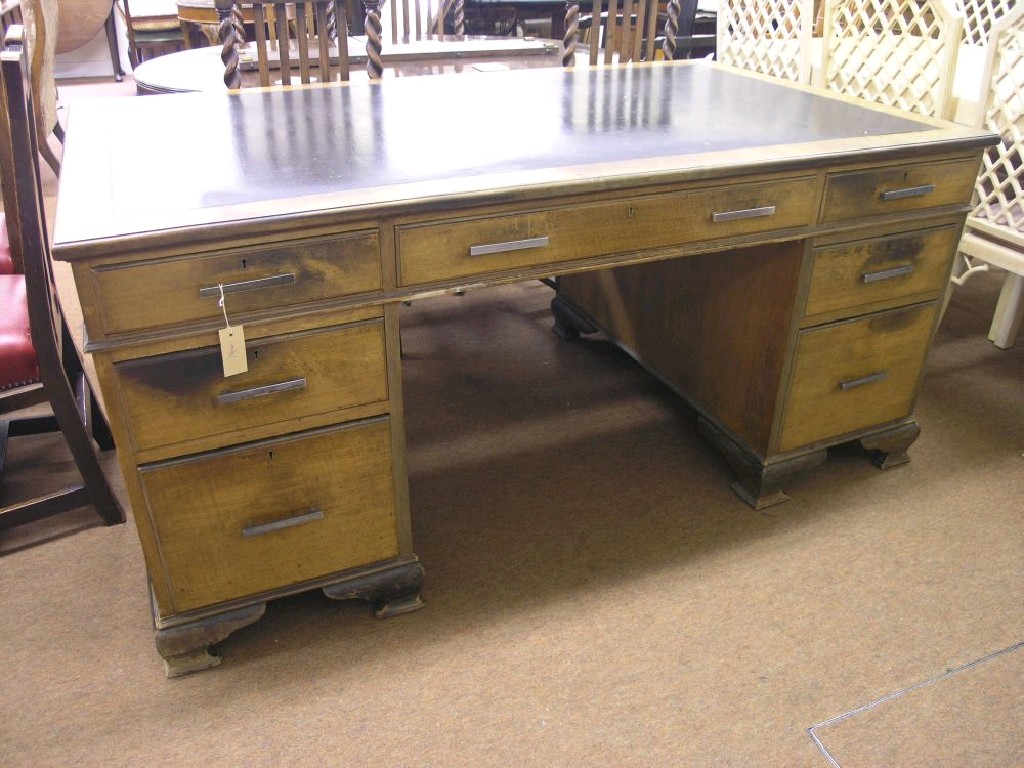 Appraisal: A large 's walnut veneered pedestal desk inset black leather