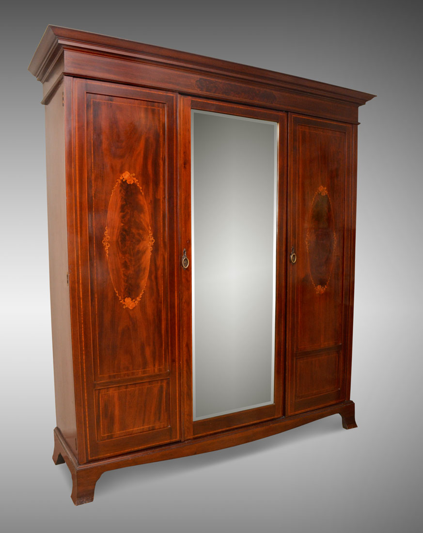 Appraisal: INLAID MAHOGANY TRIPLE DOOR ARMOIRE Stepped cornice center beveled glass