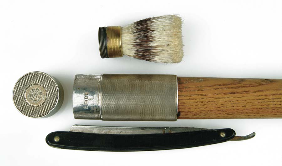 Appraisal: TOILETRY CANE With shaving brush and razor Mounted on an