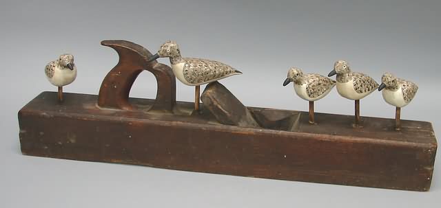 Appraisal: Grouping of five carved sandpipers on wood plane marked C