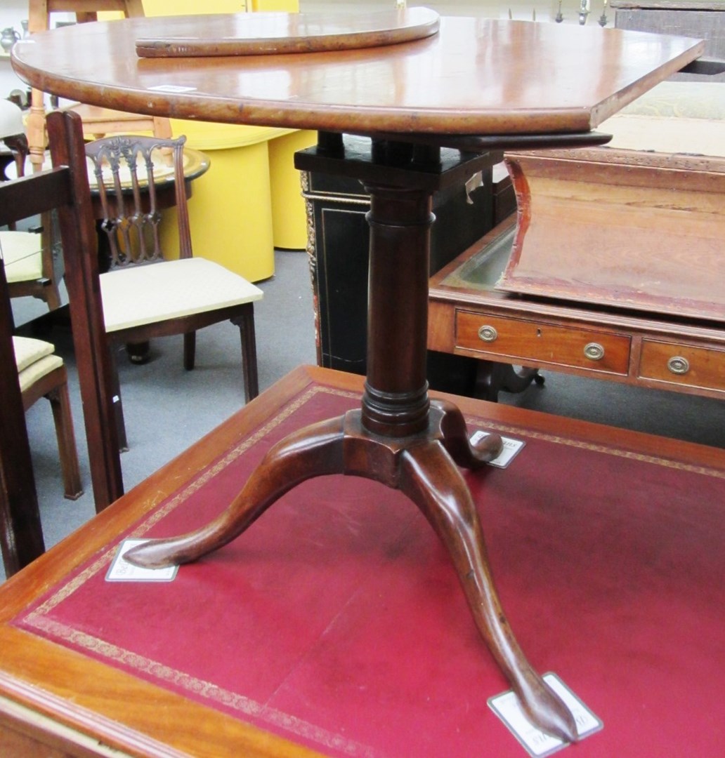 Appraisal: A George III mahogany circular snap top occasional table with