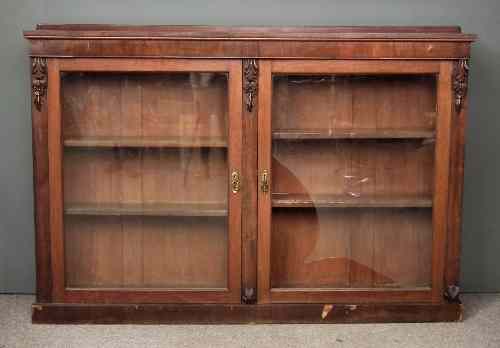 Appraisal: A Victorian mahogany dwarf bookcase with carved scroll brackets fitted