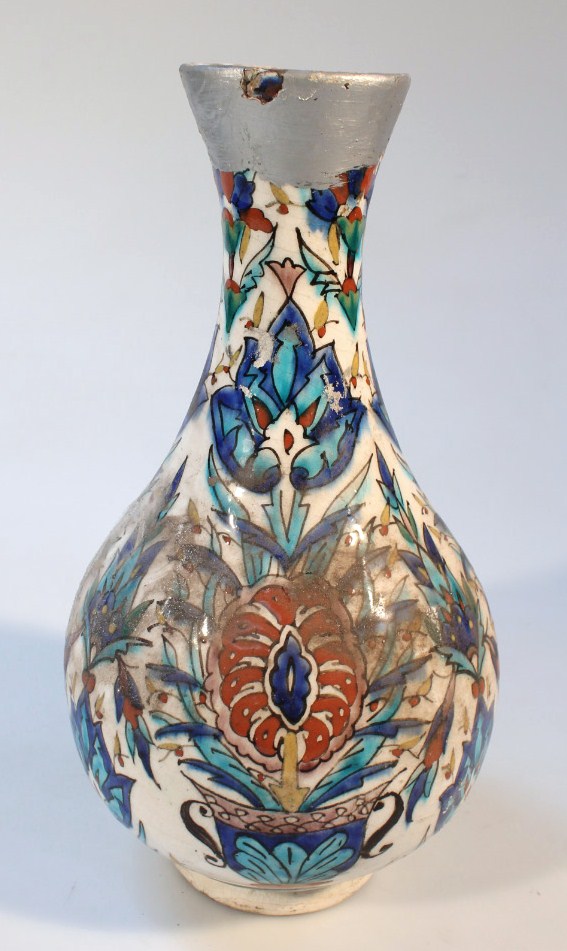 Appraisal: An Iznik pottery vase the bulbous body heavily decorated with