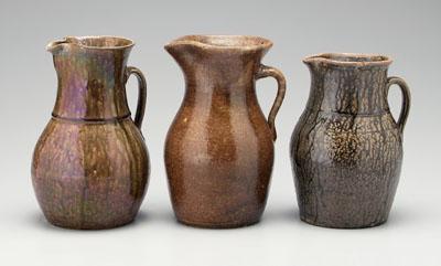 Appraisal: Three alkaline glaze pitchers one with strap handle two incised