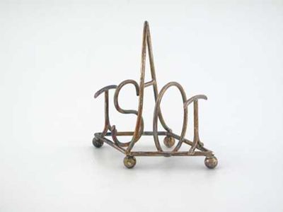 Appraisal: An Edwardian novelty wire toast rack with five bars spelling