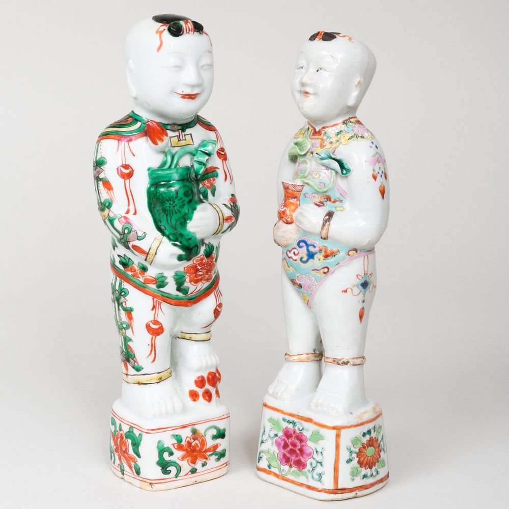 Appraisal: Two Chinese Porcelain Models of Boys Each holding a vase