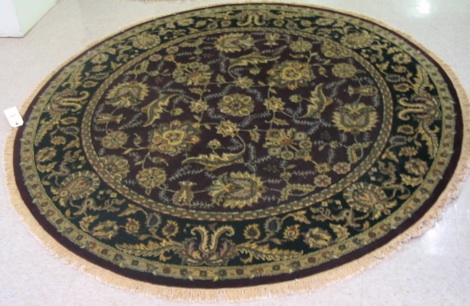 Appraisal: ROUND ORIENTAL AREA RUG Indo-Persian overall floral design on burgundy