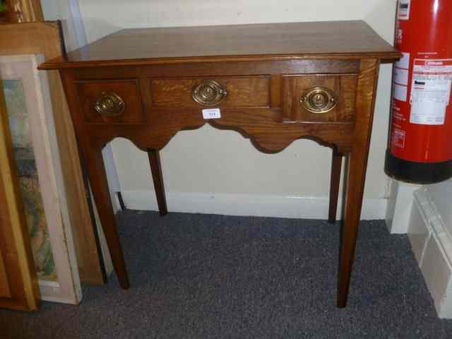 Appraisal: A GEORGIAN ELM LOWBOY fitted with three drawers with shaped